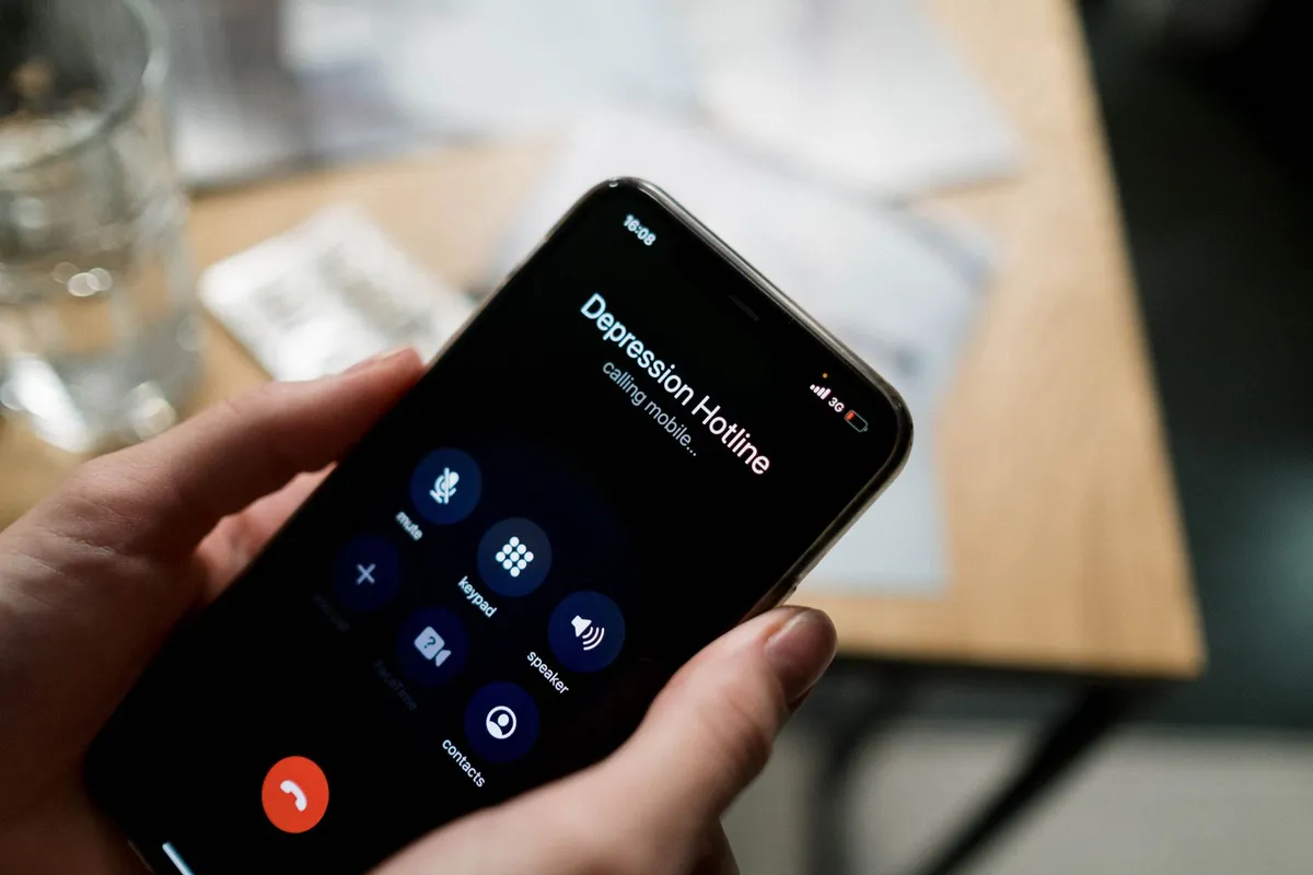 Phone screen displaying a depression hotline call in progress.
