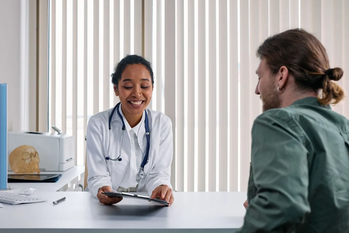 Doctor discussing care options with a patient in a clinical setting.