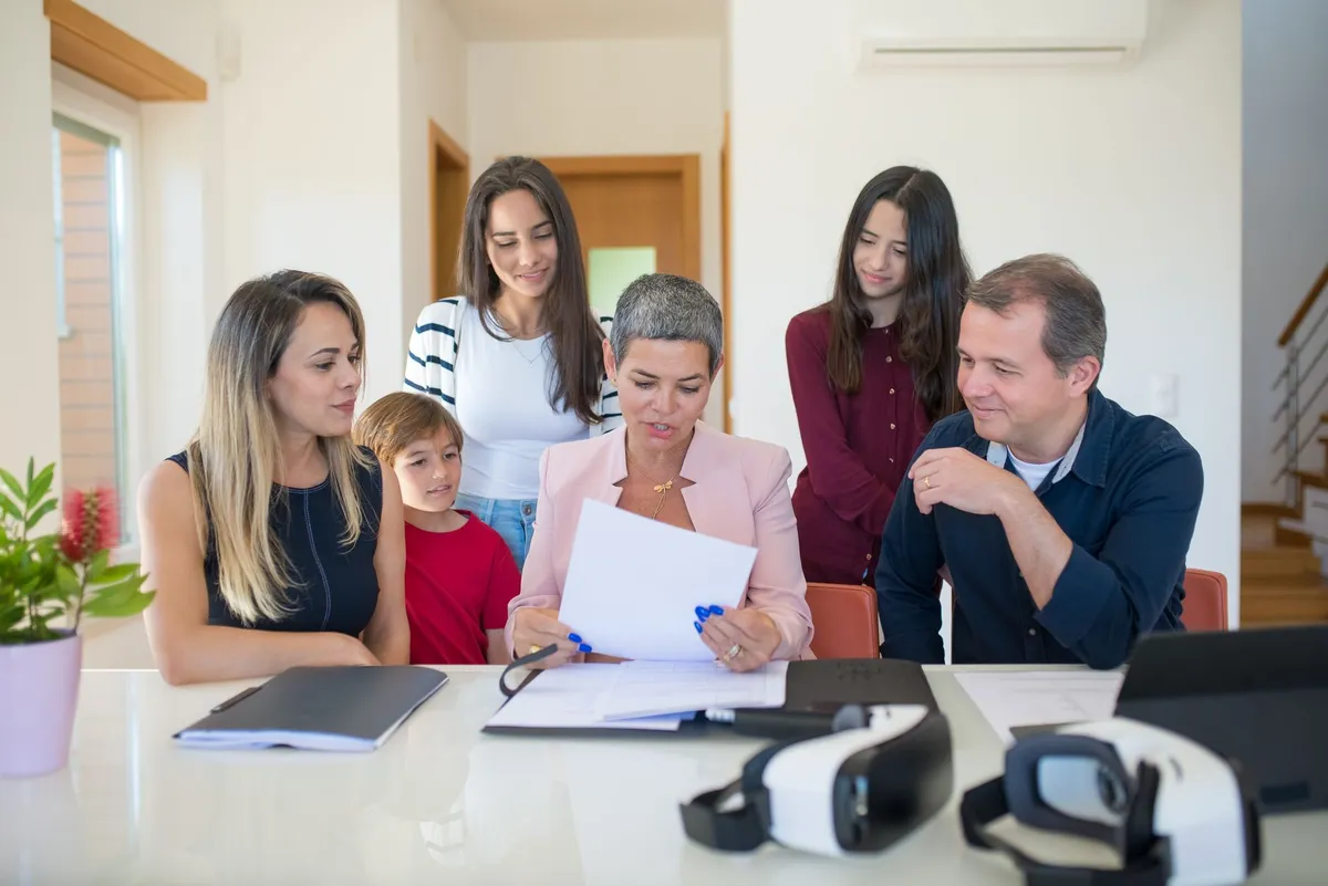 Family discussing documents related to healthcare decisions at a table.