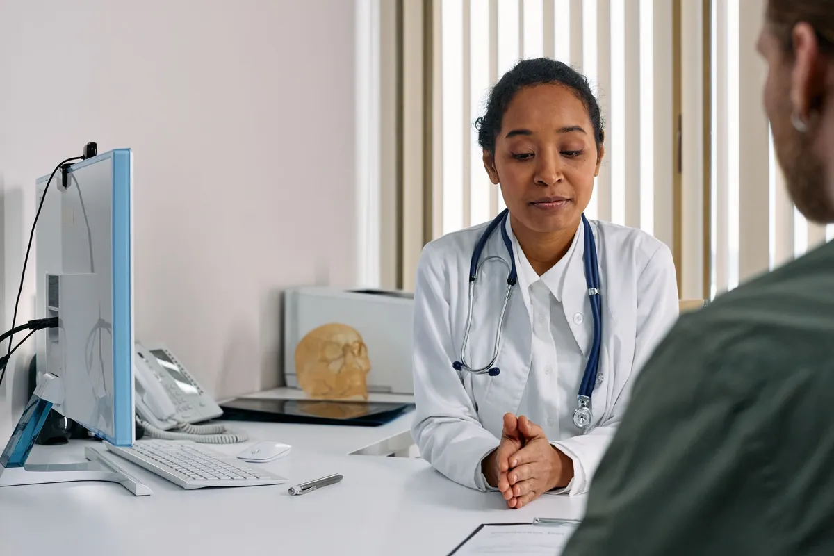 Healthcare professional discussing treatment options with a patient in an office setting.
