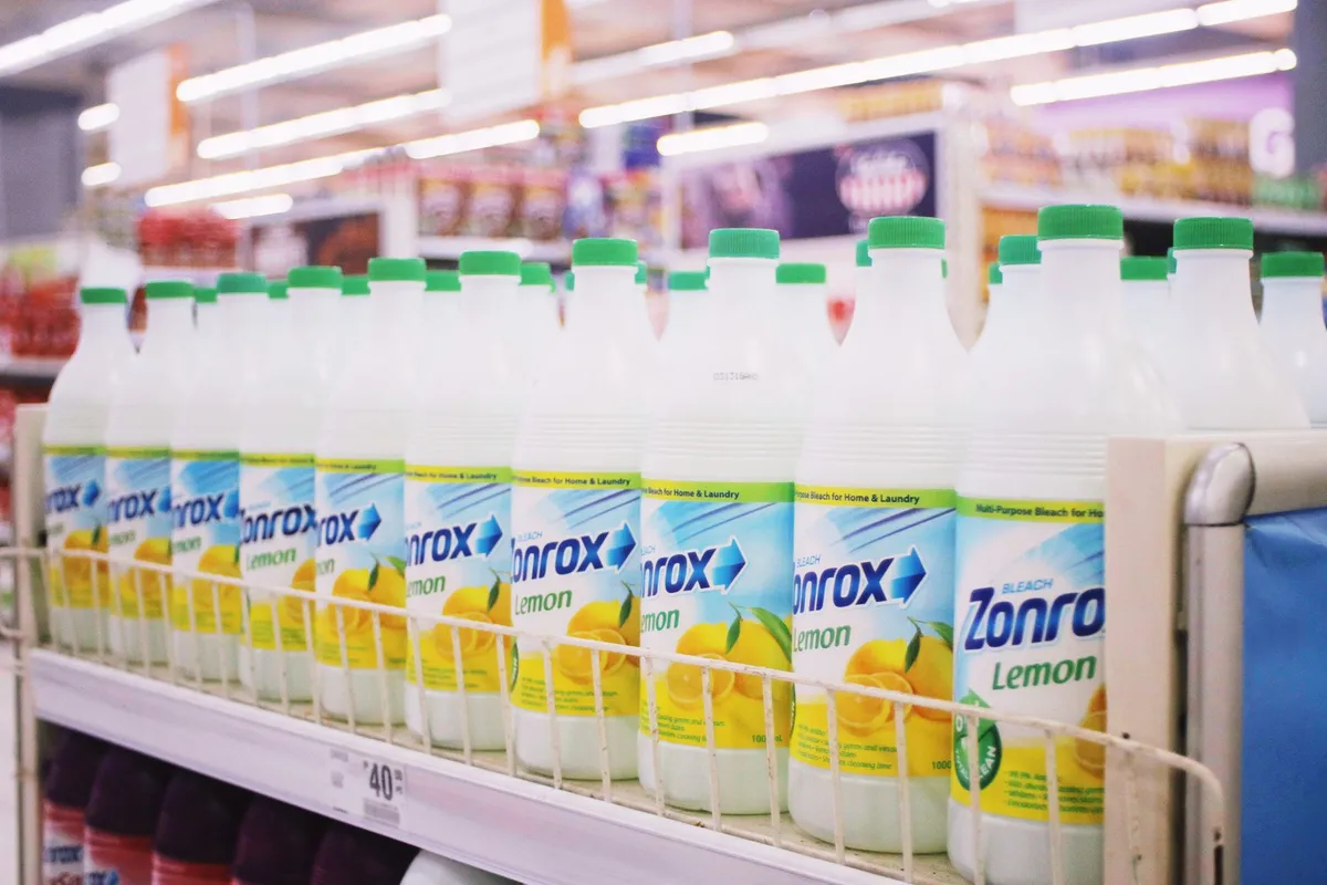 Shelves displaying various antibacterial cleaning products in a store.