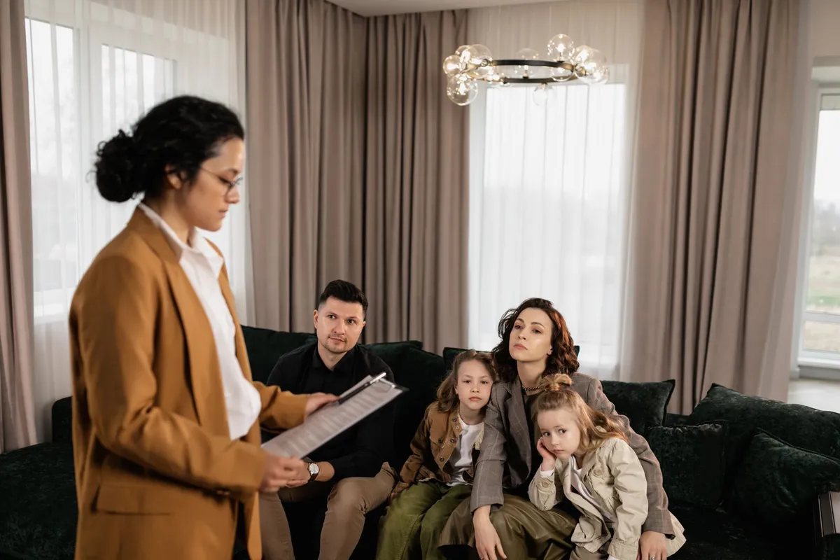 Family listening to a speaker about home safety in a living room setting.