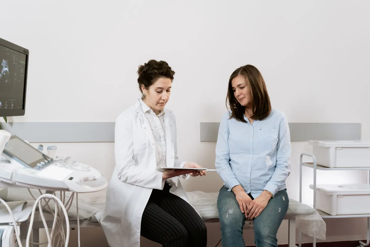 Doctor consulting with a woman in a medical setting about fertility options.