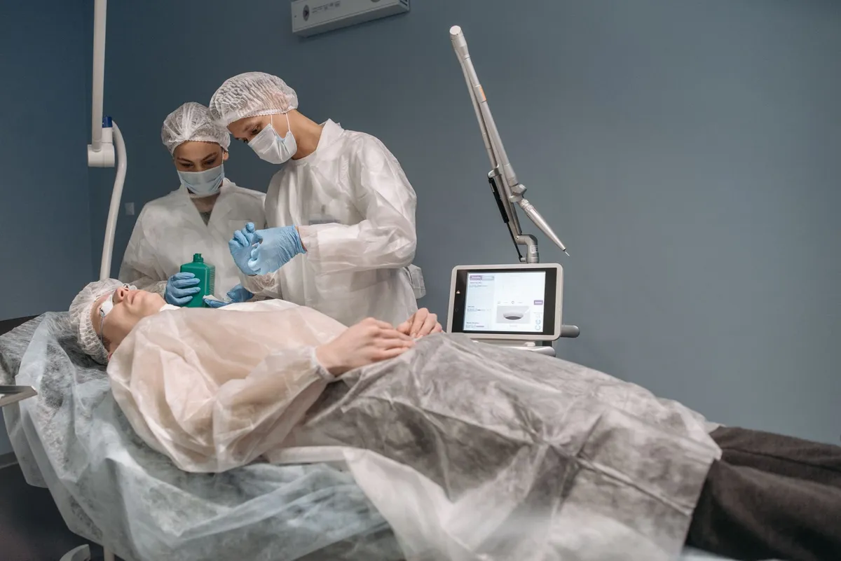 Medical professionals preparing for eyelid surgery in a clinical setting.