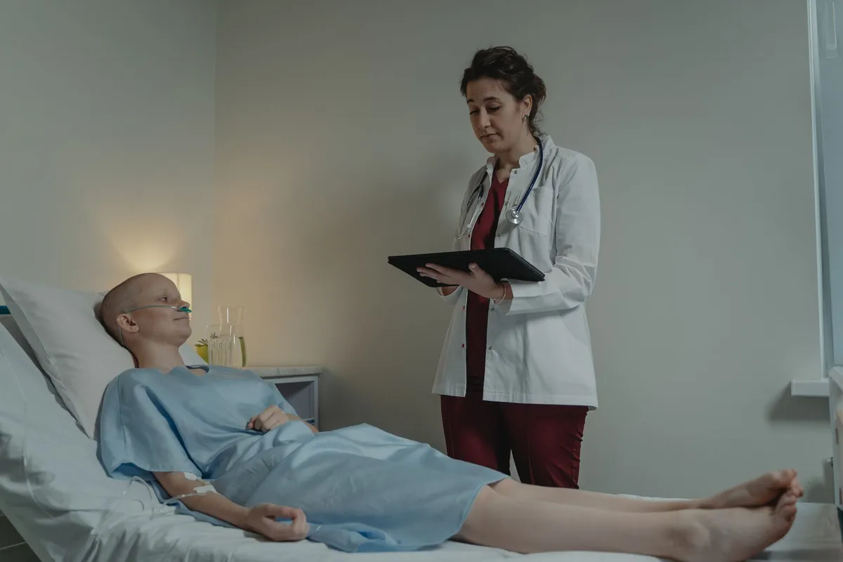 A healthcare professional discussing treatment with a patient in a clinical setting.