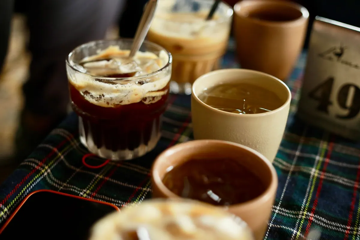 Various caffeinated drinks including iced coffee and tea on a table.