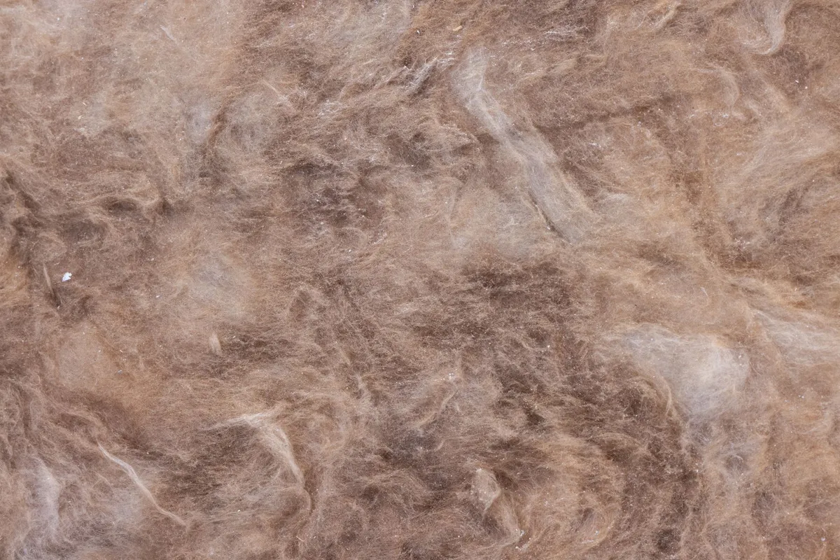 Close-up of brown fibrous material resembling asbestos insulation