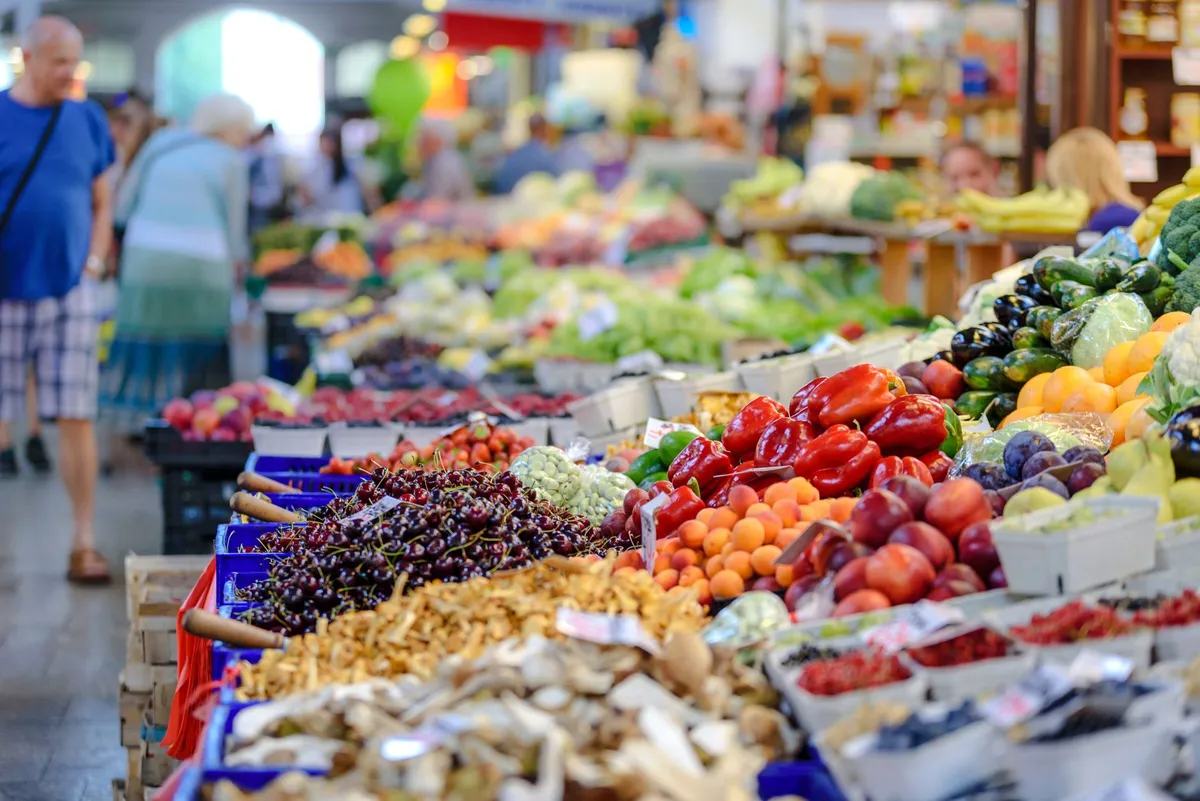 Vibrant display of fresh fruits and vegetables at a market stall.