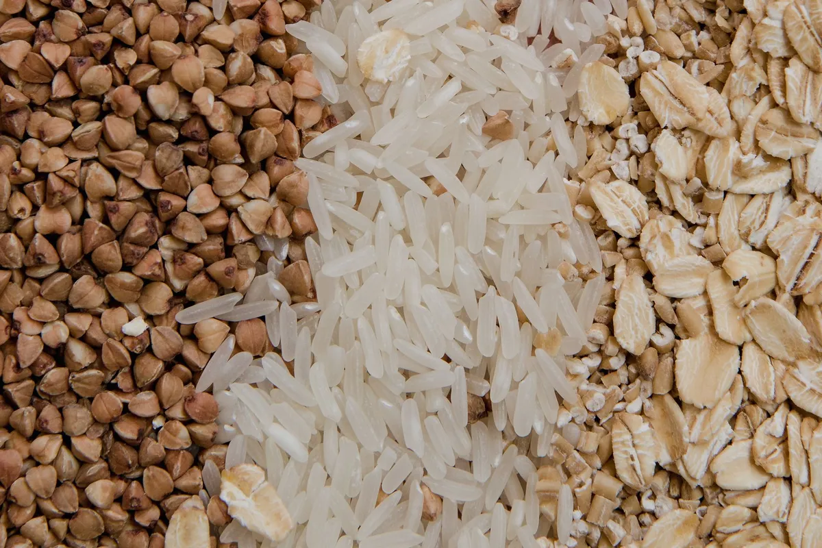 Close-up of buckwheat, rice, and oats arranged in sections.