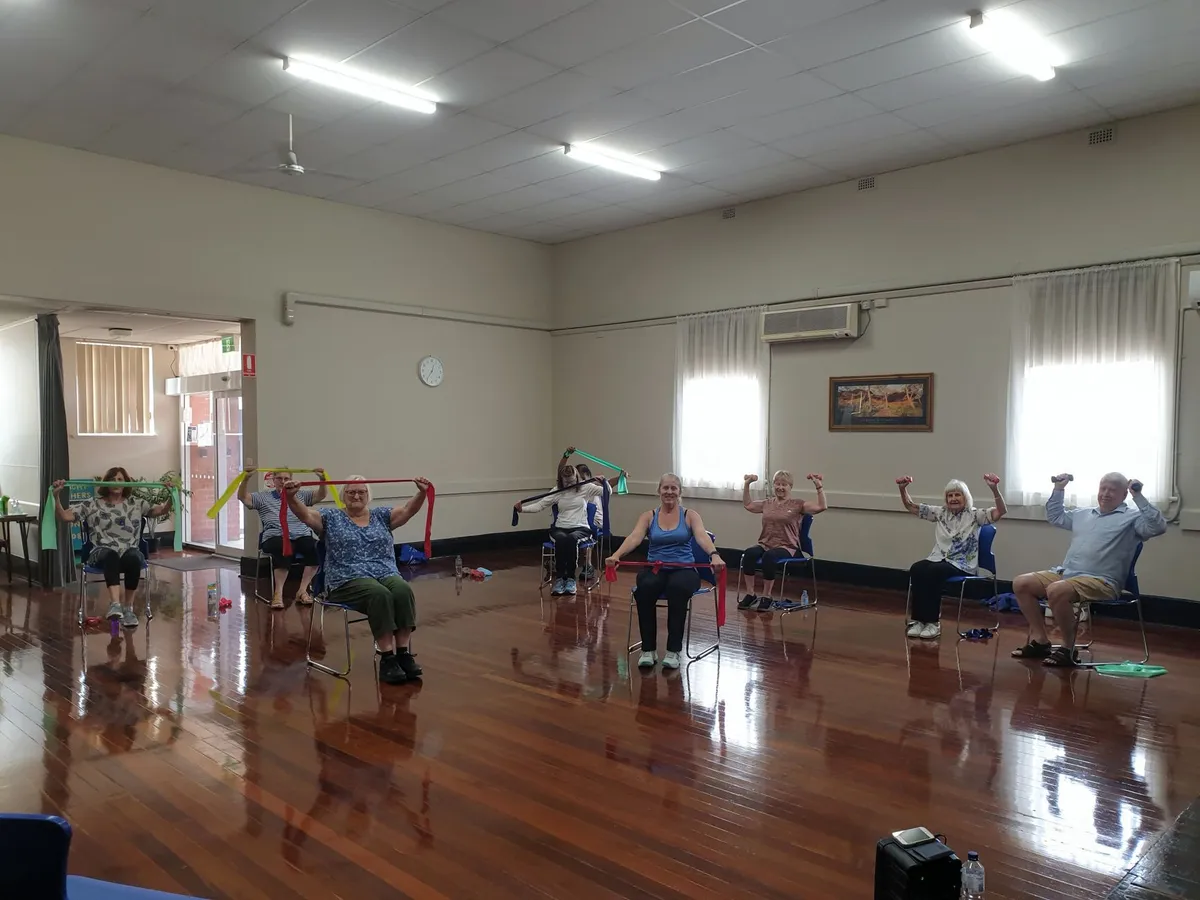 Seniors participating in a seated exercise class with resistance bands.