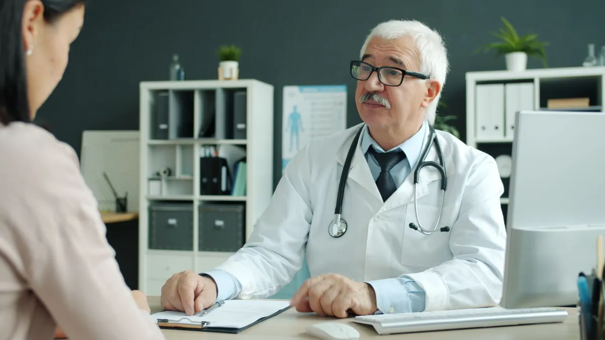 Doctor consulting with a patient in a medical office setting.