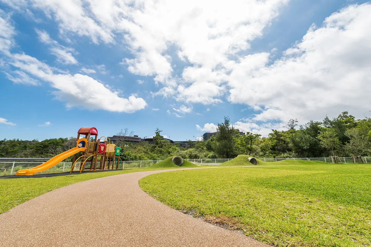 Playground with slides and grassy area, suitable for young children to play together.