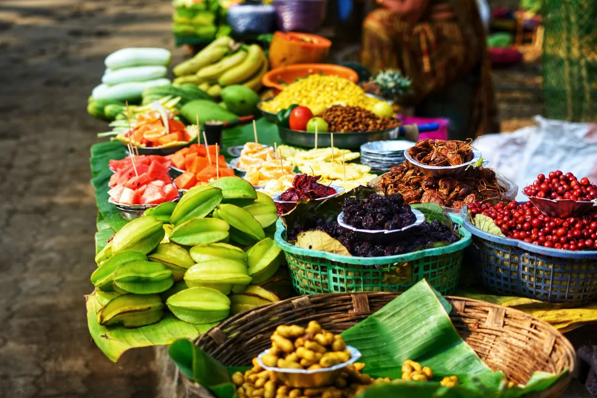 Colorful display of various fruits and vegetables at a market stall.