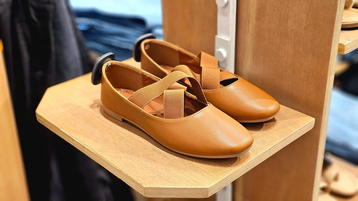 Brown children’s shoes on display in a store setting.