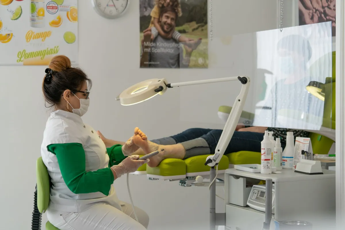 Podiatrist examining a patient’s foot in a clinical setting.