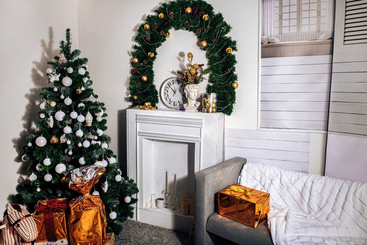 Cozy living room with a decorated Christmas tree and gifts by the fireplace.