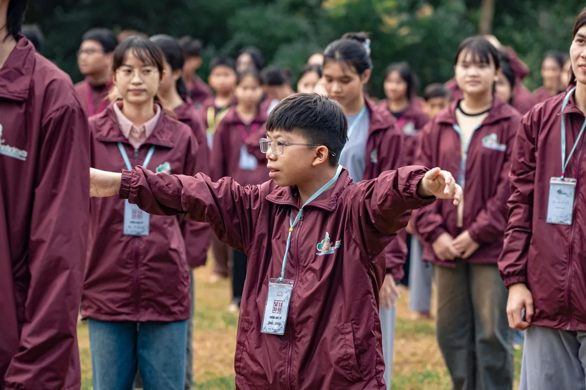 Students in matching jackets participating in an outdoor group activity.