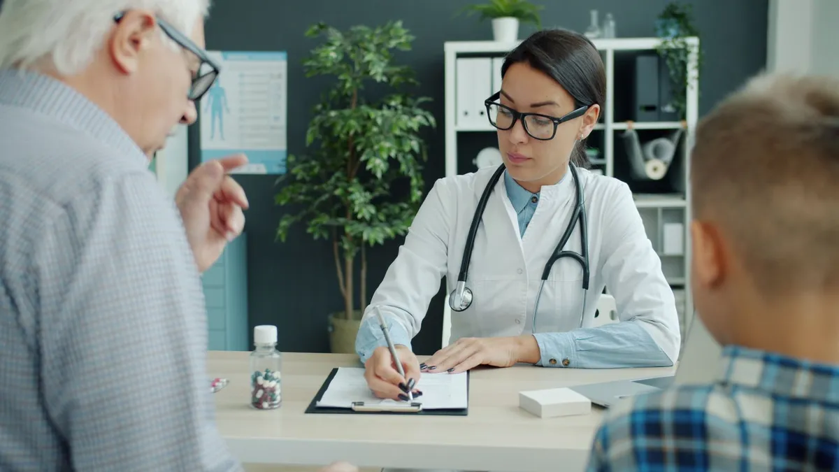 Healthcare professional discussing treatment options with a senior and a child.
