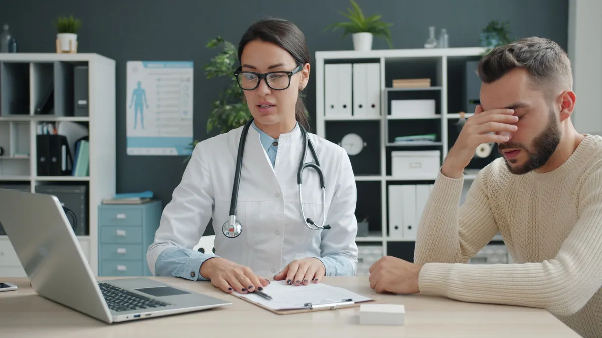 Healthcare provider discussing treatment options with a patient in an office setting.