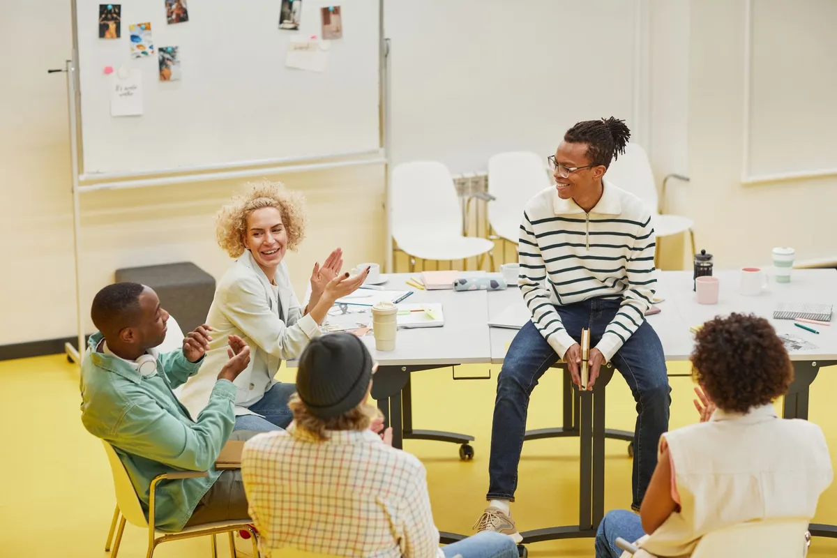 Group discussing health resources in a community meeting setting with a whiteboard.
