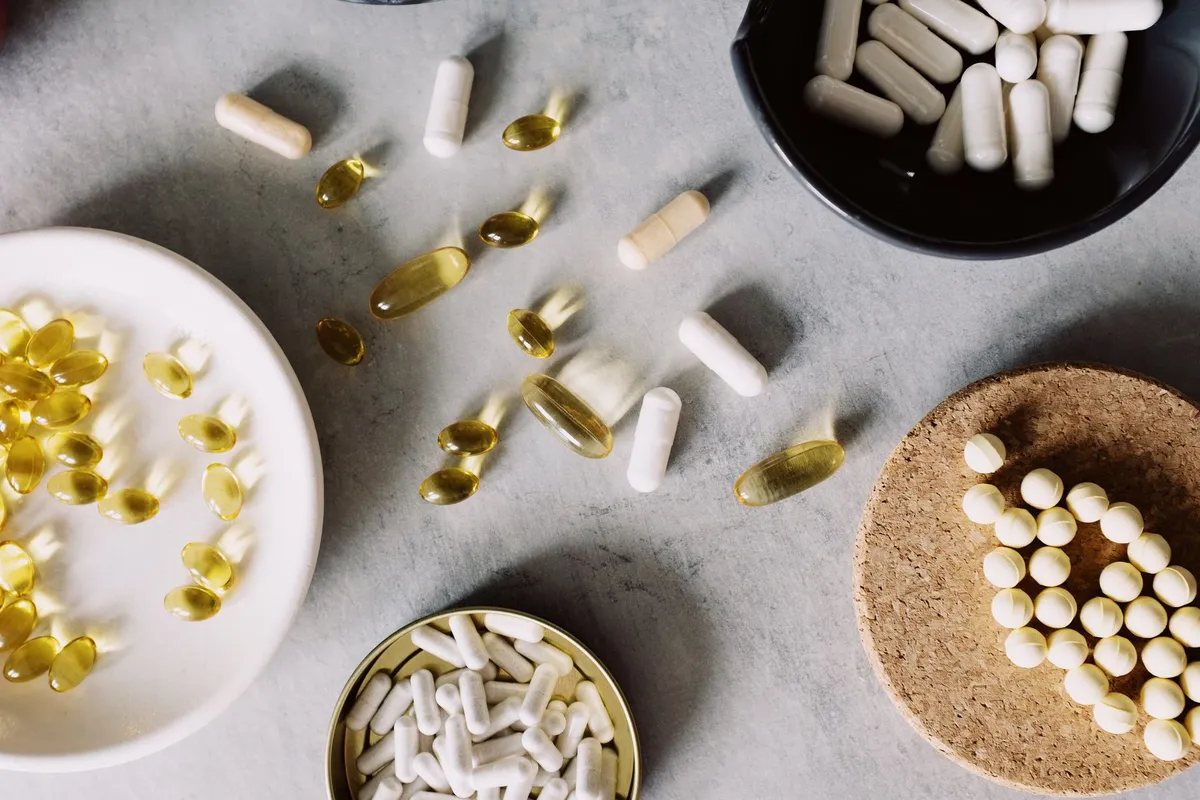 Various dietary supplements including capsules and pills on a surface.