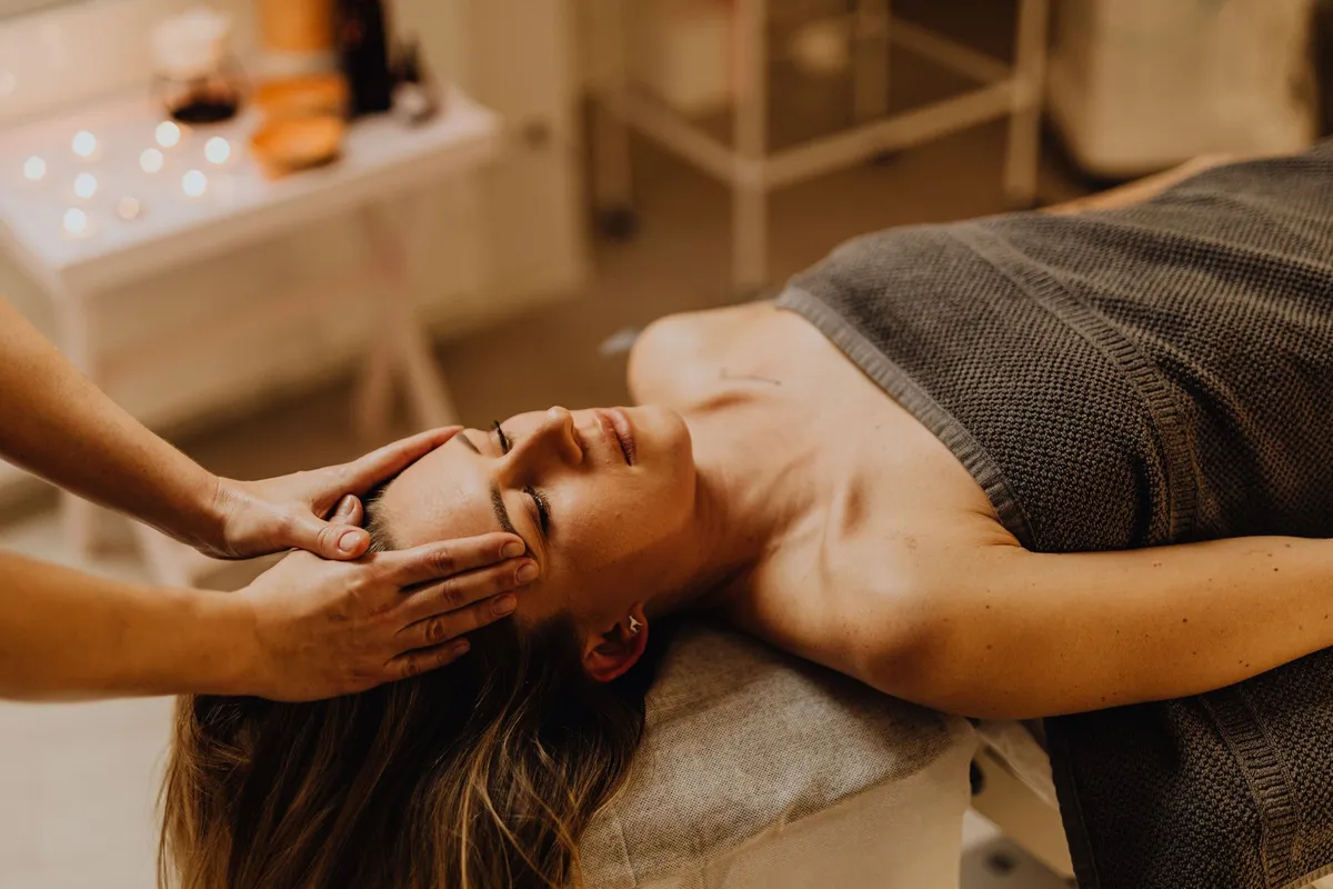 Woman receiving a facial massage in a wellness center