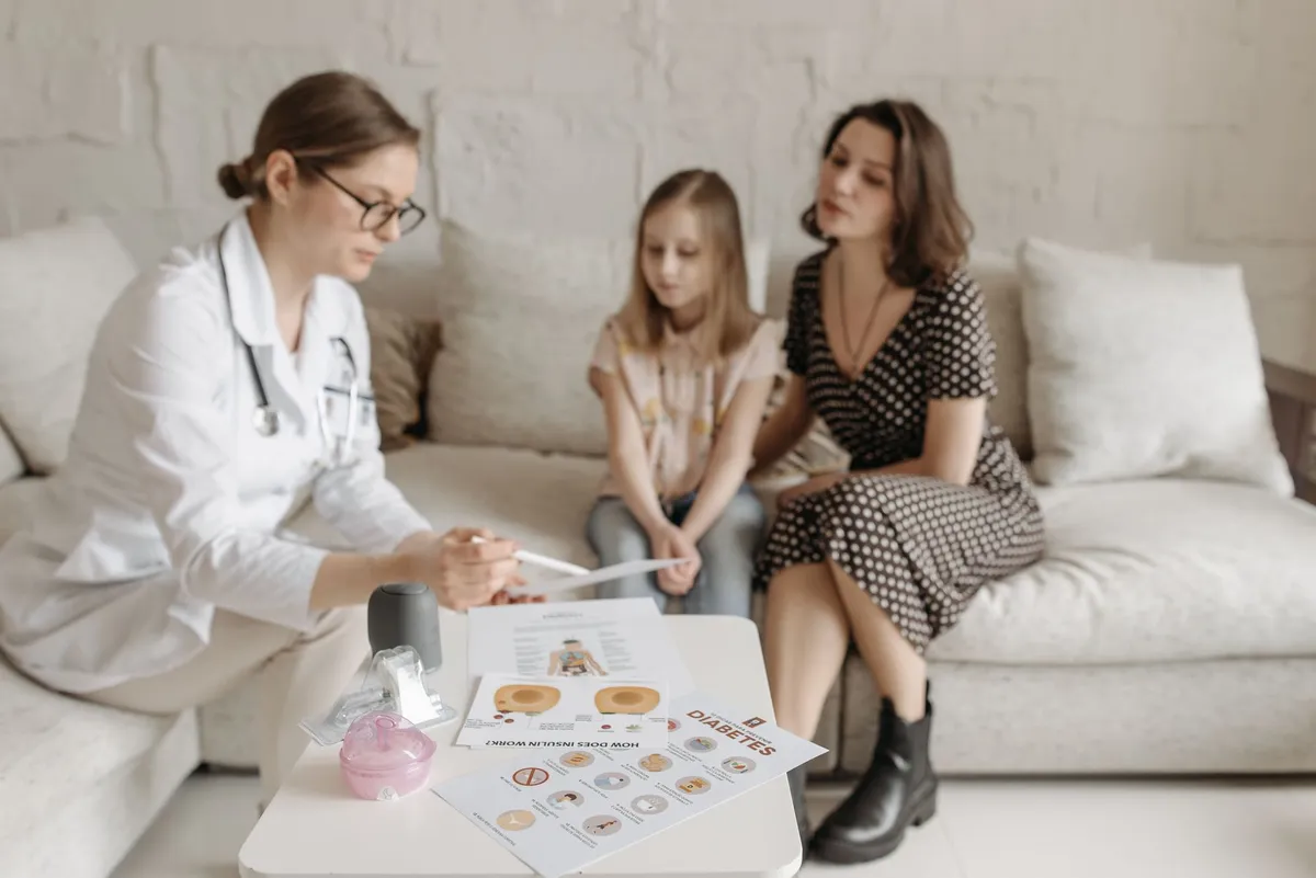 Healthcare professional discussing congenital anomalies with a mother and daughter.