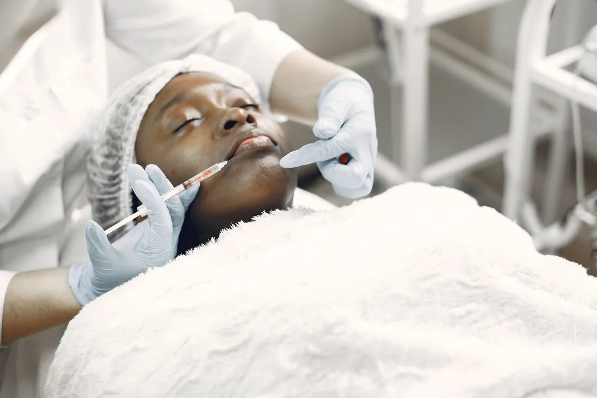 Patient receiving a cosmetic injection in a clinical setting.