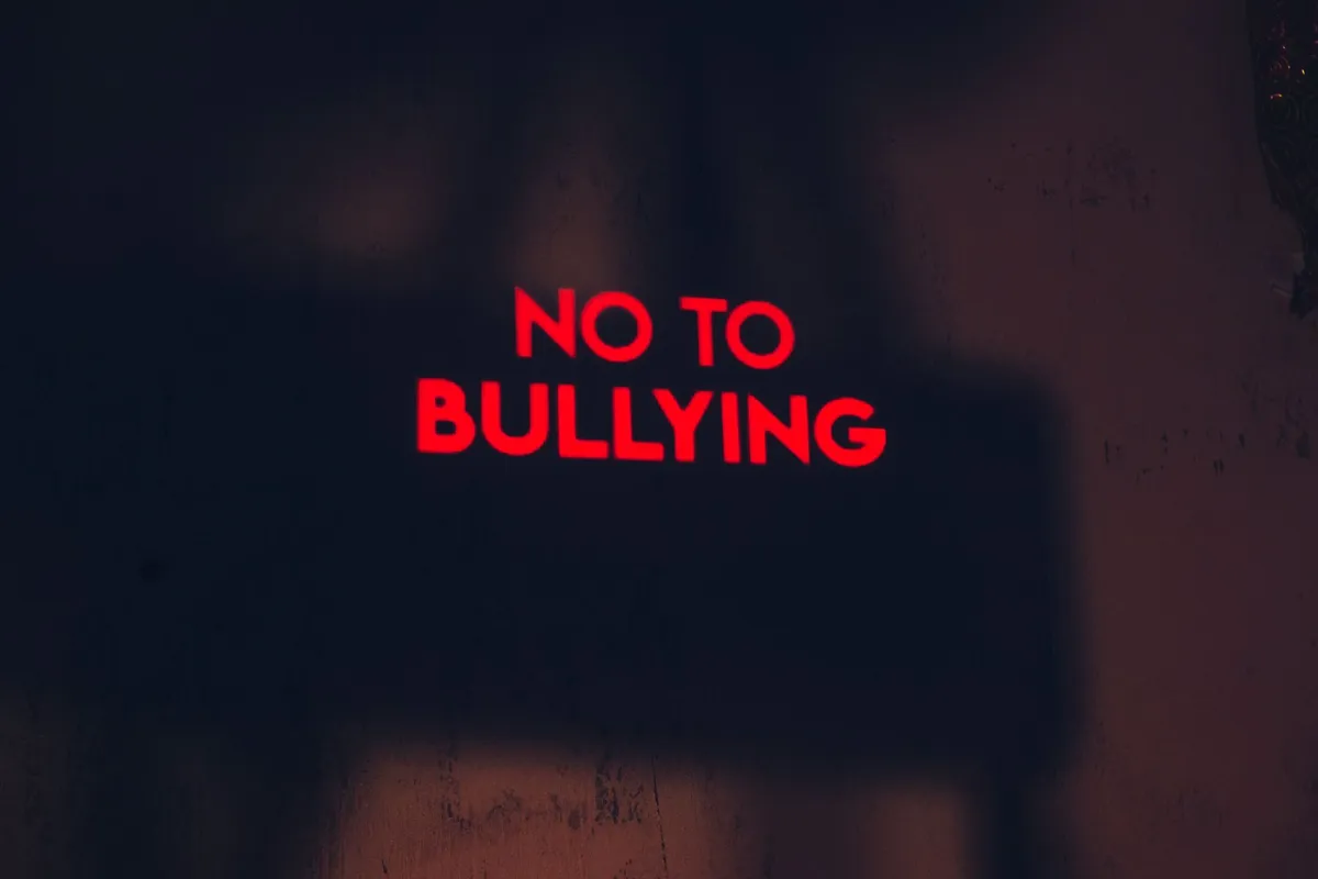 Red text on a wall stating ‘NO TO BULLYING’
