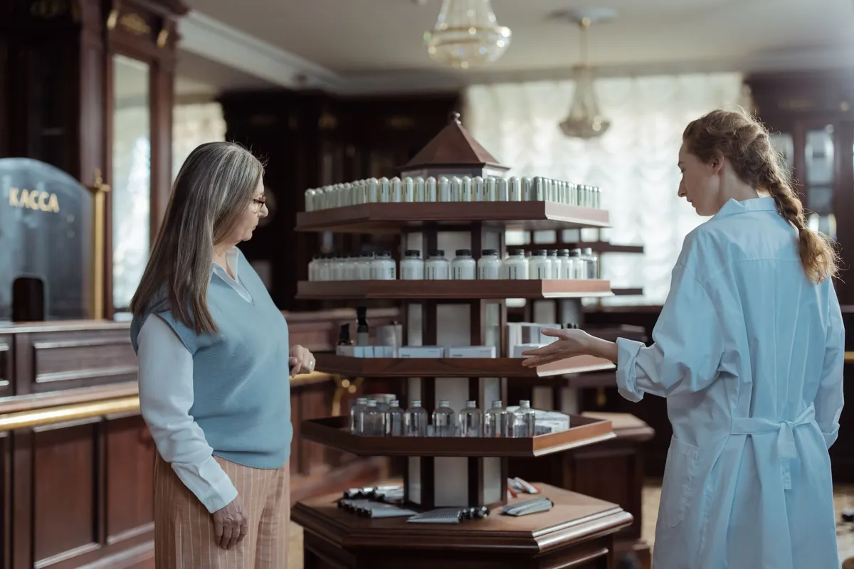 A pharmacist assisting a customer in a pharmacy with health products.