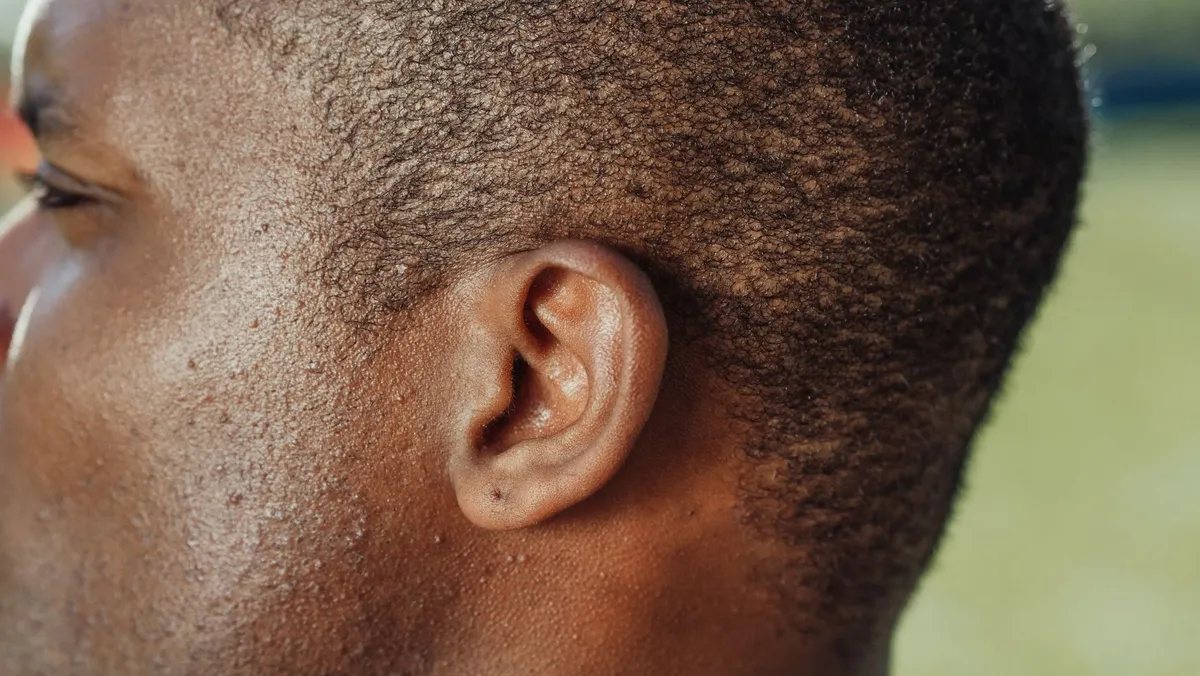 Close-up of a human ear showing its structure and details.